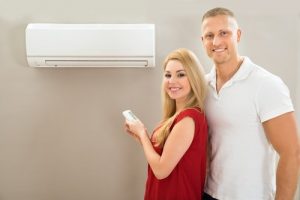 happy couple with air conditioner